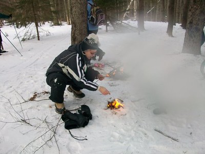 Man making fire in the snow