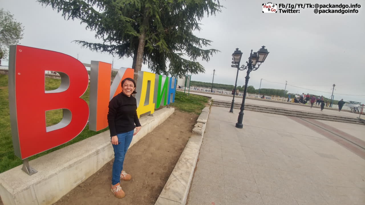 Woman next to the Vidin sign in Vidin