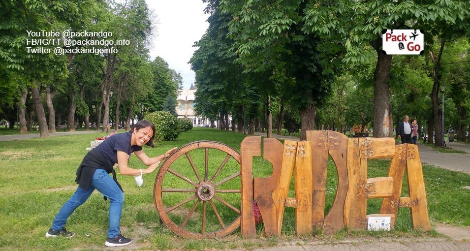 Woman at the tourist city sign,  Oradea, Romania