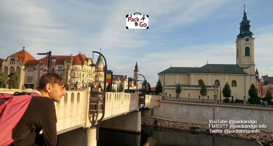 Man observing the Crișul Repede river and surrounding buildings from a bridge, Oradea, Romania
